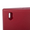 Close up of red doorsense showing the fixing point hole on a red textured surface