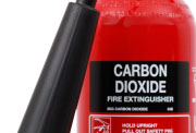 A red CO2 fire extinguisher with a black label