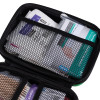 Open mesh pouch containing assorted first aid supplies, including cotton swabs, wipes, bandages, and a thermal blanket organised in compartments.