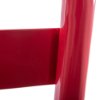 Close up of a single red metal extinguisher stand showing smooth shiny surface and part of its frame