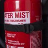 Close up of water mist extinguisher held by securing strap inside double extinguisher cabinet