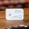 Kidde 2030 dcr carbon monoxide alarm shown on a wooden surface with buttons and indicator lights visible