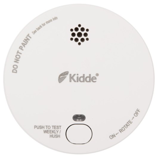 Front view of a round smoke alarm with a test button and ventilation holes visible