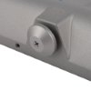 Closeup of the adjuster on a rutland overhead door closer silver showing the screw and surrounding metal parts