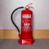 ultrafire 6l water mist on red fire point showing a red fire extinguisher on a stand against a plain wall