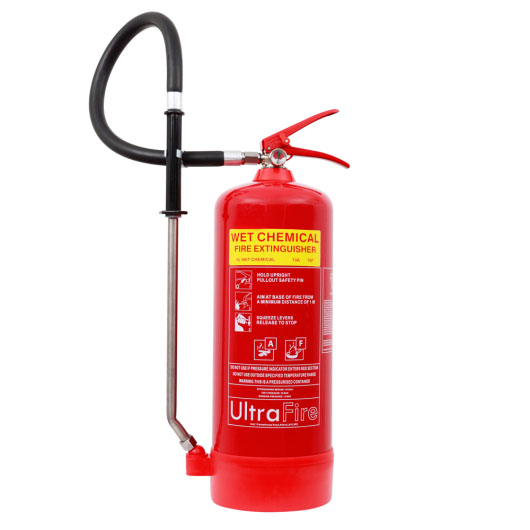 A red wet-chemical fire extinguisher with a yellow label