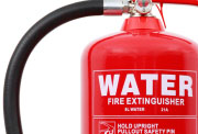 A red water fire extinguisher with a red label